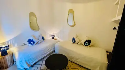 a bedroom with two beds with blue pillows at Riad Fabiola Et Spa By La Siredrah in Marrakech