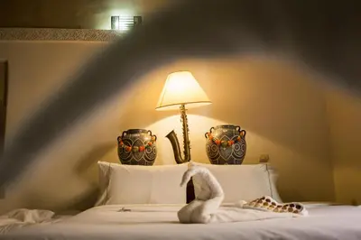 a bedroom with a bed with a swan on it at Riad Zanzibar in Marrakech