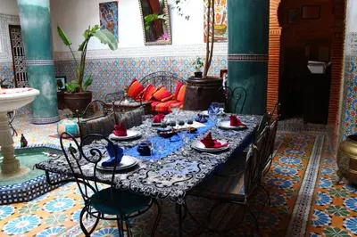 a table with glasses and dishes on it in a room at Riad Bibtia in Marrakech