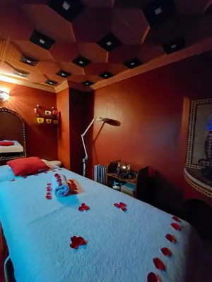 a bedroom with a bed with red roses on it at Riad Kenzo in Marrakech