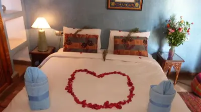 a bedroom with a bed with a heart on it at Riad Kenzo in Marrakech