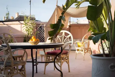 a table and chairs with oranges on a patio at Riad Assala in Marrakech