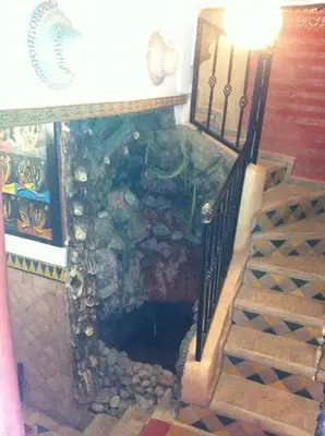 a room with a fire place with a stair case at Riad Tarik in Marrakech