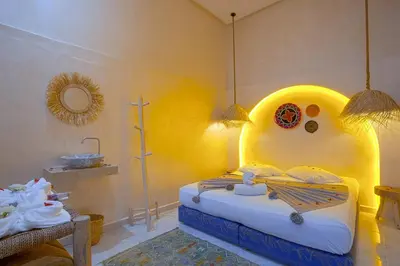 a bedroom with a bed and a sink in it at Riad El Kennaria in Marrakech