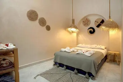 a bedroom with a bed with towels on it at Riad El Kennaria in Marrakech