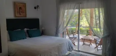 a bedroom with a bed and a balcony with a patio at Luxury appartement 105m2-hivernage-Sofitel in Marrakech