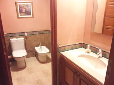 a bathroom with a toilet and a sink and a mirror at Luxury appartement 105m2-hivernage-Sofitel in Marrakech