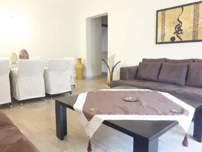 a living room with a couch and a coffee table at Luxury appartement 105m2-hivernage-Sofitel in Marrakech