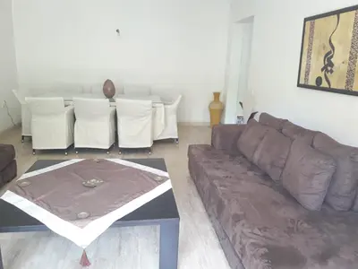 a living room with a brown couch and a table at Luxury appartement 105m2-hivernage-Sofitel in Marrakech