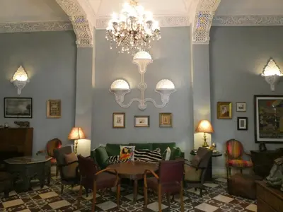 a dining room with a chandelier and a table and chairs at Palais El Arsat & Spa in Marrakech
