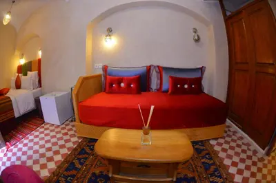 a bedroom with a bed and a table in a room at Riad Hidden in Marrakech