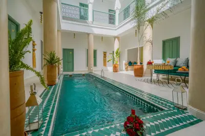 a swimming pool in a house with a christmas ornament at Riad Trésor in Marrakech