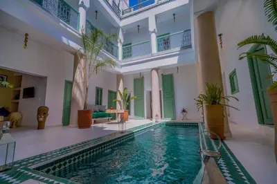 a swimming pool in a large building with a swimming poolvisor at Riad Trésor in Marrakech