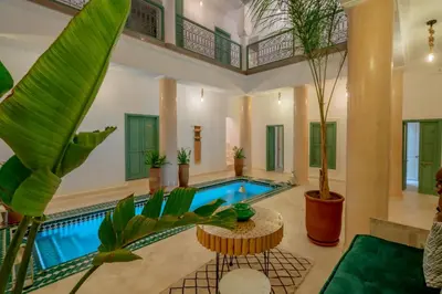 an indoor pool in a house with plants at Riad Trésor in Marrakech
