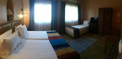 a bedroom with a bed and a couch in a room at Villa Des 3 Golfs in Marrakech