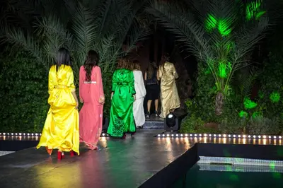 a group of women walking down a runway at a fashion show at Villa Des 3 Golfs in Marrakech