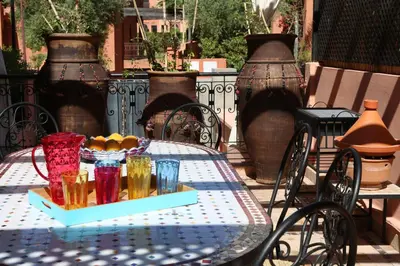 a table with a blue and white table cloth and vases at Villa Nelya in Marrakech