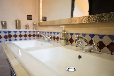 a bathroom with two sinks and a mirror at Villa Nelya in Marrakech
