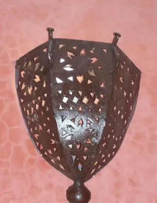 a black umbrella is hanging on a wall at Riad Essaoussan in Marrakech
