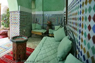 a room with a bed and a couch in a room at Riad Essaoussan in Marrakech