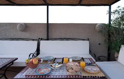 a table with plates of food and drinks on it at Riad Adrar in Marrakech