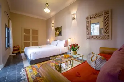 a hotel room with a bed and a couch at Riad Adrar in Marrakech