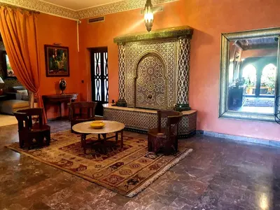 a room with a table and chairs in a room at Villa Amira & Spa in Marrakech