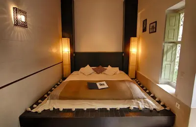 a bedroom with a bed with a book on it at Dar Crystal in Marrakech
