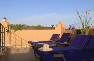 a group of purple chairs sitting on a patio at Riad Houdou in Marrakech