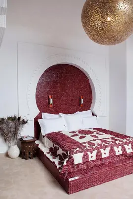 a bedroom with a bed with a red headboard at P´tit Habibi in Marrakech