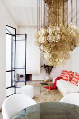 a living room with a large chandelier at P´tit Habibi in Marrakech