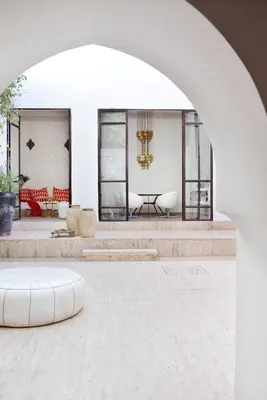 an archway in a building with a bench and a table at P´tit Habibi in Marrakech