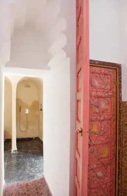 a red door in a room with a shower at P´tit Habibi in Marrakech