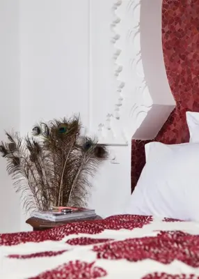 a bedroom with a bed with a red and white blanket at P´tit Habibi in Marrakech