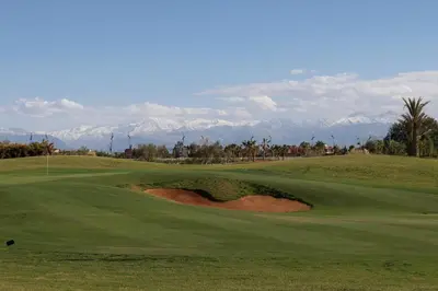 a view of a golf course with mountains in the background at golf city Av Med VI in Marrakech