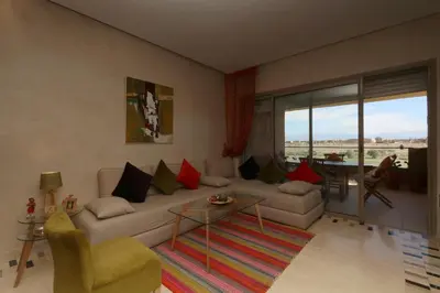 a living room with a couch and a table at golf city Av Med VI in Marrakech
