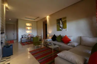 a living room with a couch and a table at golf city Av Med VI in Marrakech