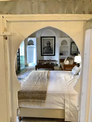 a bedroom with a large bed with an archway at Riad Hadika Maria in Marrakech
