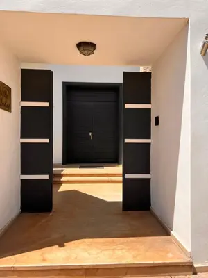 a room with a garage with a door and a window at Villa DAAB OURIDA piscine chauffée Salle de sport in Marrakech