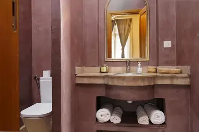 a bathroom with a sink and a toilet and a mirror at Marrakech Pearl in Marrakech