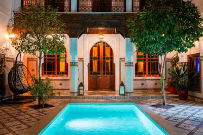 a swimming pool in front of a house at Ysalis Riad Restaurant & Spa in Marrakech