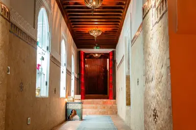 a hallway with a dog sitting on the floor in a building at Ysalis Riad Restaurant & Spa in Marrakech
