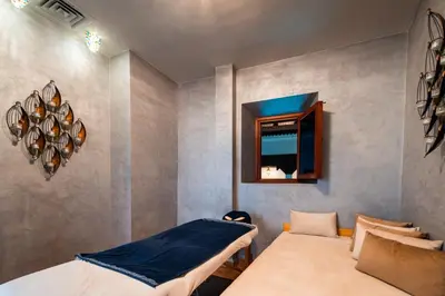 a bedroom with two beds and a mirror at Ysalis Riad Restaurant & Spa in Marrakech
