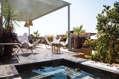 a patio with a pool with chairs and a table at Riad Danka in Marrakech