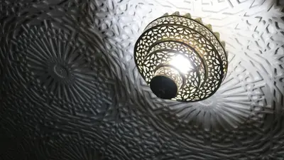 a light hanging from the ceiling of a room at Dar Habache in Marrakech
