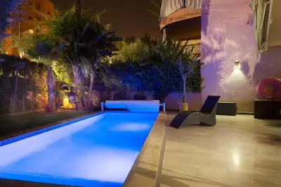 a swimming pool in a building at night at The Sapphire Apartment with Private Swimming Pool & Hot Tub - Hivernage Quarter - By Goldex Marrakech in Marrakech
