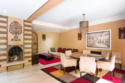 a living room with a table and a couch at The Sapphire Apartment with Private Swimming Pool & Hot Tub - Hivernage Quarter - By Goldex Marrakech in Marrakech