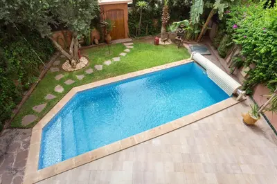 an image of a swimming pool in a backyard at The Sapphire Apartment with Private Swimming Pool & Hot Tub - Hivernage Quarter - By Goldex Marrakech in Marrakech