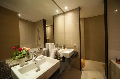a bathroom with two sinks and a large mirror at Villa Loubane in Marrakech