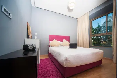a bedroom with a large bed and a window at Villa Loubane in Marrakech